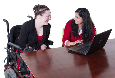 A woman with disability and another woman looking at a computer