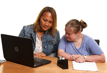 A mother and daughter looking at a computer together