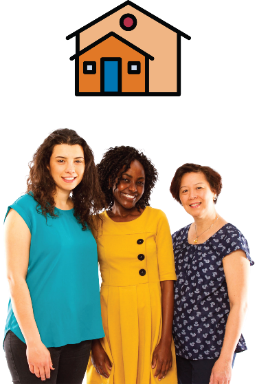 3 women standing together smiling with a house next to them